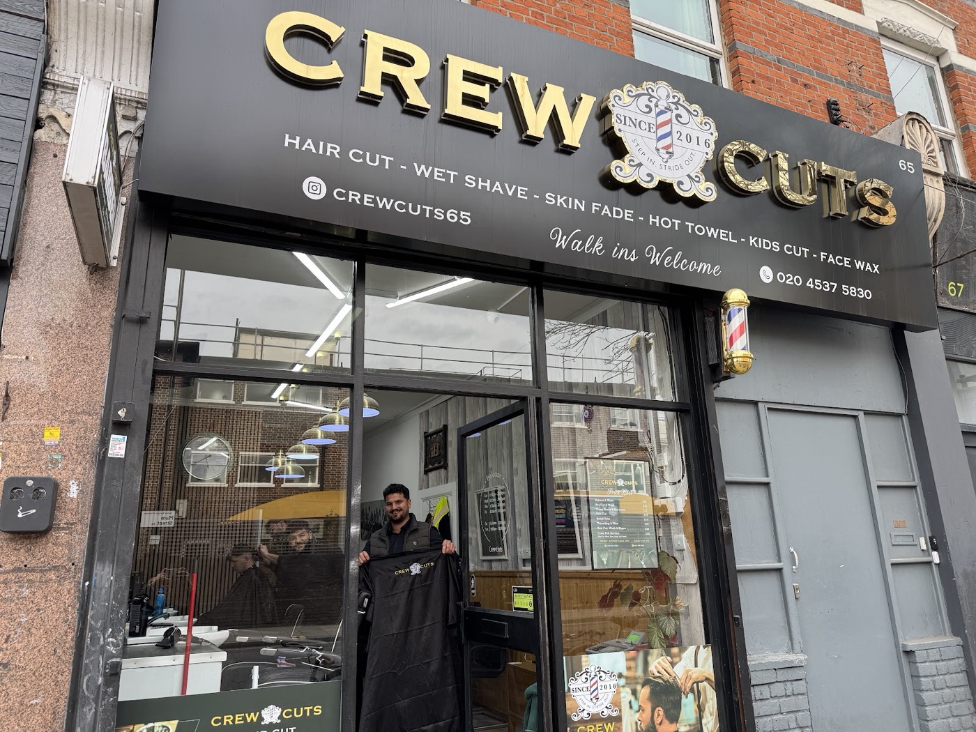 The Crew Cuts shopfront on Mare Street, Hackney, with its gold lettering and barber pole